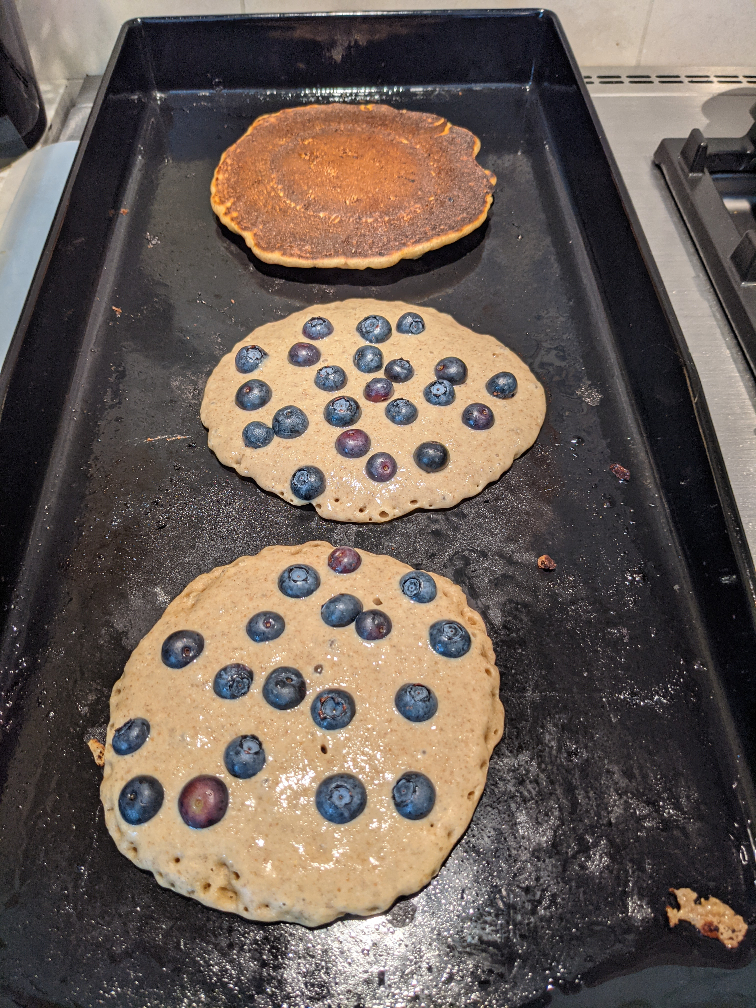 Rye Pancakes cooking on a griddle.